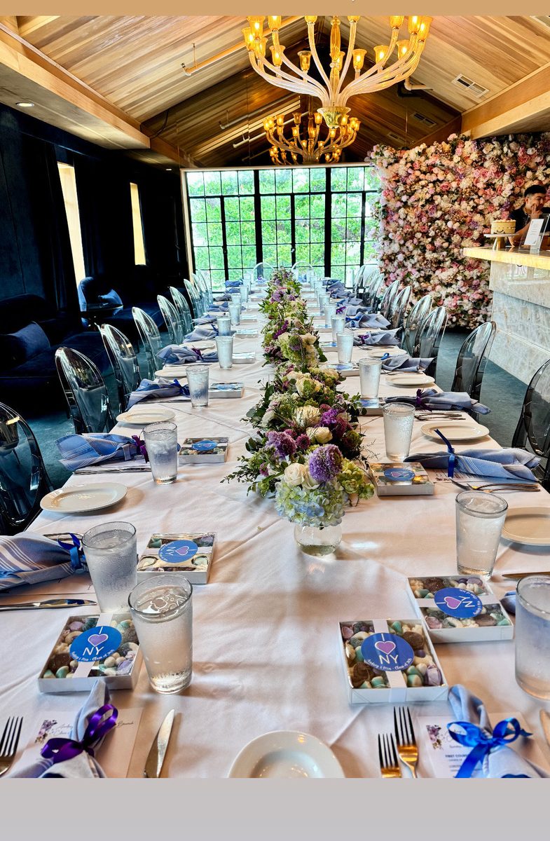 A graduation dinner table beneath antler chandeliers.